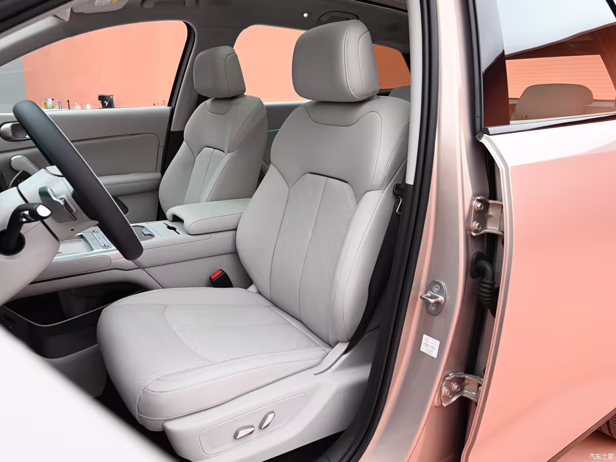 BYD Yuan Plus interior with large touchscreen, wireless charging pad, and ambient lighting front seats
