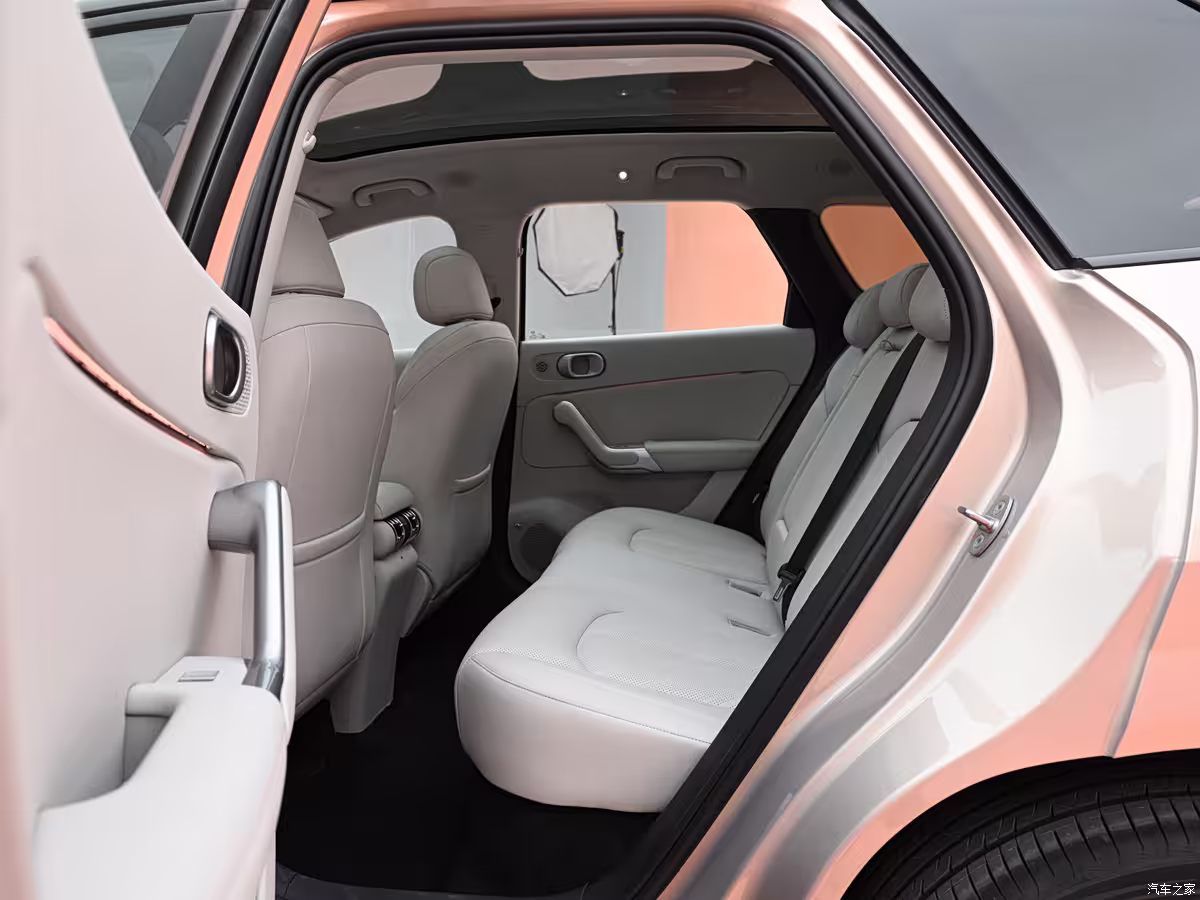 BYD Yuan Plus interior with large touchscreen, wireless charging pad, and ambient lighting rear seats